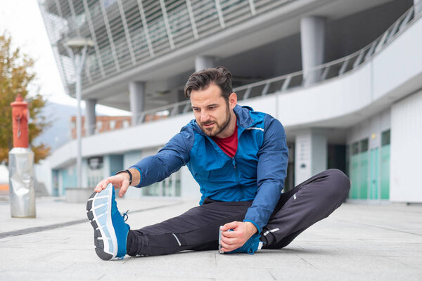 Getting muscles warm doing legs stretching exercise
