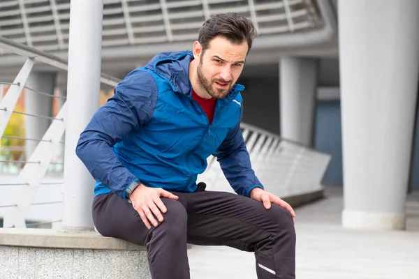 Active man resting during urban running training