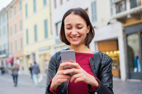 stock image Woman typing on smart phone for urban city communication