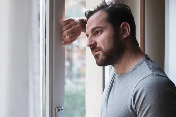 Besorgter Mann Schaut Nachdenklich Aus Dem Fenster — Stockfoto