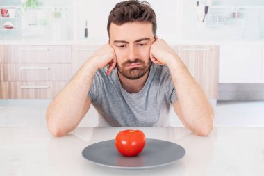 Üzgün adam diyet kilo kaybı için salata yemeye hazır