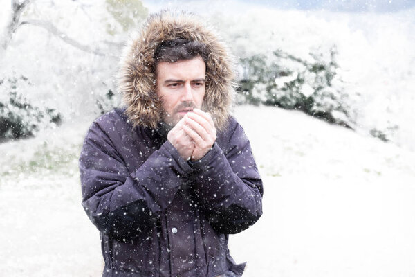 Man in cold and snowy weather storm in winter