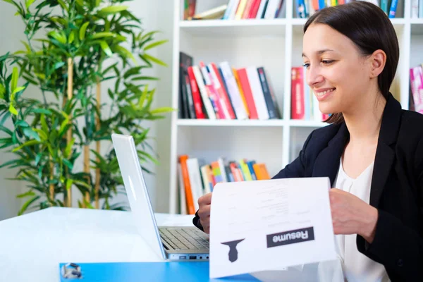 Woman writing curriculum resume for job interview