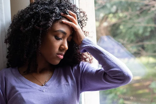 Black girl watching out of the window