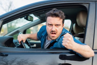 Driver frustrated portrait while driving his car clipart