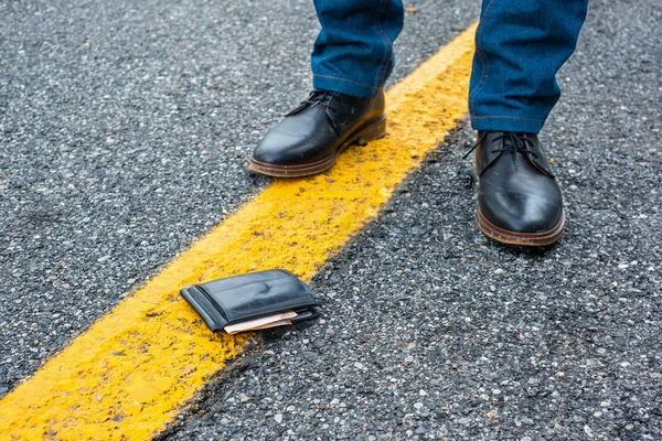Black wallet with cash is lying lost on the pavement — Stock Photo, Image