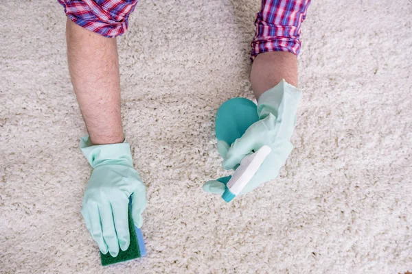 Wiping wooden white carpet and floor with a sponge — Stock Photo, Image