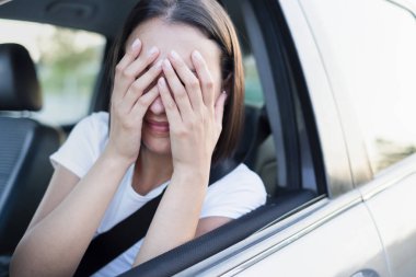 Stresli kadın sürücü arabasında oturuyor.