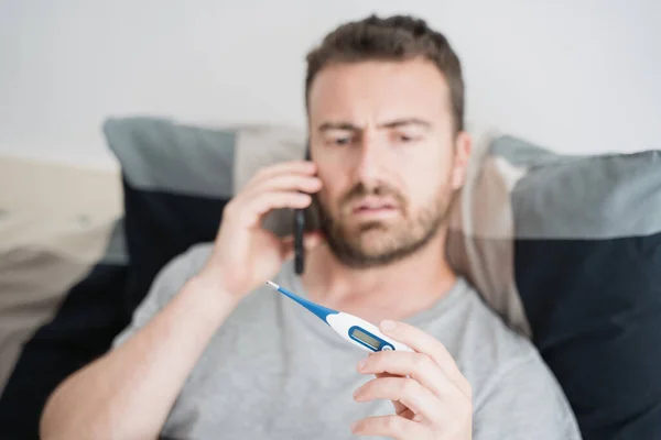 Sick man asking doctor a consultation using phone
