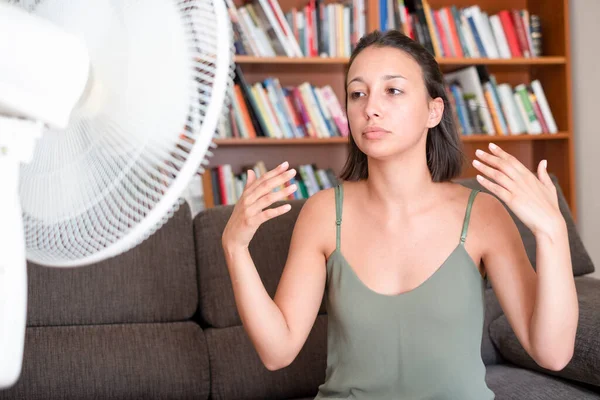 Woman suffering for summer heat cooling at home