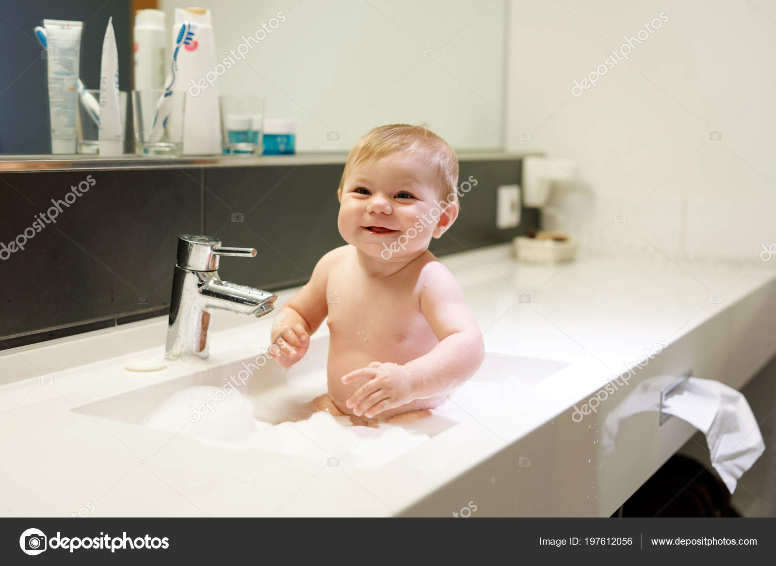 Cute Adorable Baby Taking Bath In Washing Sink And Playing