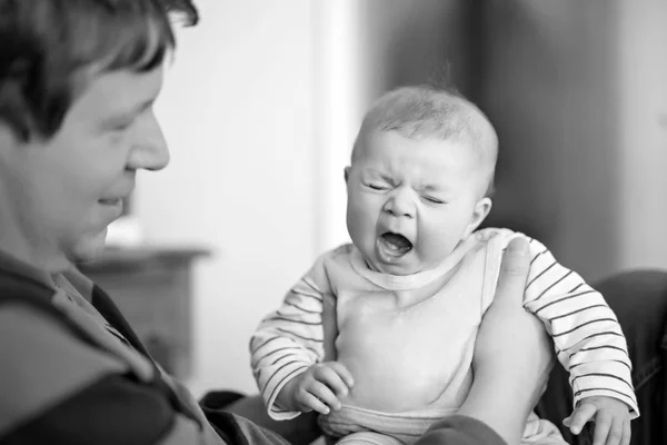 Happy proud young father with newborn baby daughter, family portrait togehter