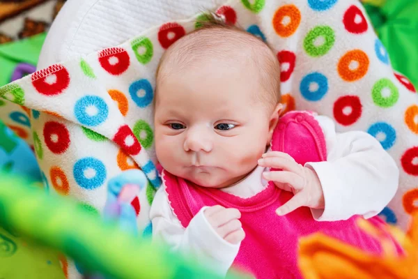 Cute adorable newborn baby playing on colorful toy gym — Stock Photo, Image