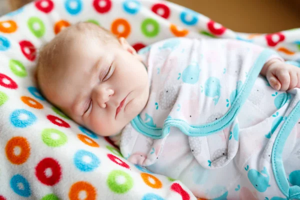 Cute little newborn baby girl sleeping wrapped in blanket — Stock Photo, Image