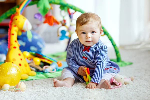 Adorable baby girl playing with educational toys in nursery — Stock Photo, Image