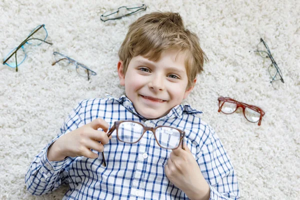 Close-up portrait of little blond kid boy with brown eyeglasses — Stock Photo, Image