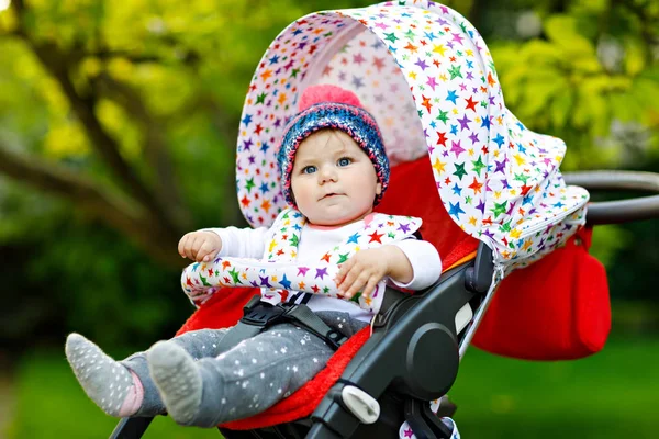 Cute little beautiful baby girl of 6 months sitting in the pram or stroller and waiting for mom — Stock Photo, Image