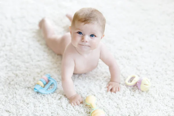 Bonito bebê brincando com colorido pastel brinquedo chocalho vintage. Criança recém-nascida, menina olhando para a câmera e rastejando. Família, nova vida, infância, conceito inicial. Aprendizado bebê. — Fotografia de Stock