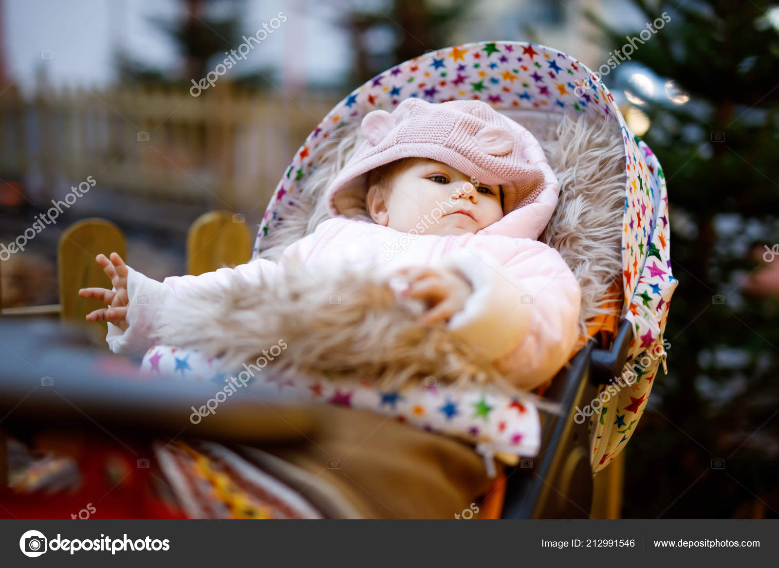Cute Little Beautiful Baby Girl Sitting In The Pram Or Stroller On