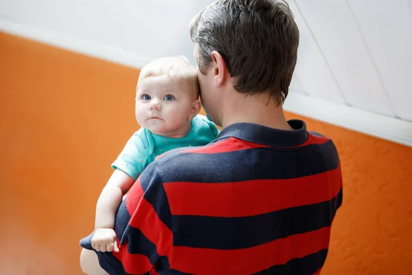 Happy proud young father having fun with newborn baby daughter, family portrait togehter. Dad with baby girl, love. Bonding, family, new life. — Stock Photo, Image