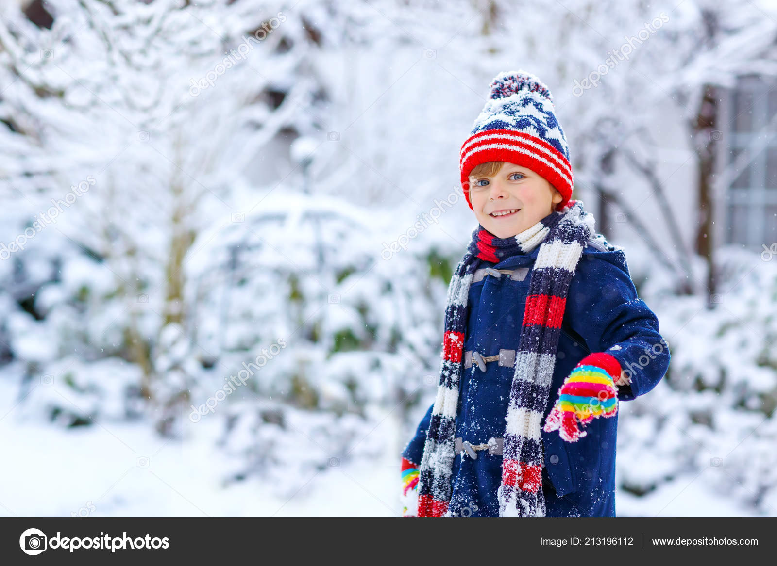 Cute little funny child in colorful winter fashion clothes having fun and  playing with snow, outdoors during snowfall. Active outdoors leisure with  children. Kid boy and toddler catching snowflakes. Stock Photo by ©