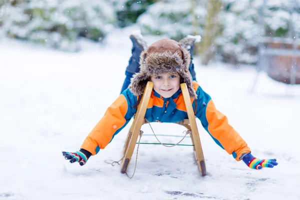 Little kid boy having fung with sleigh ride in winter — Stock Photo, Image