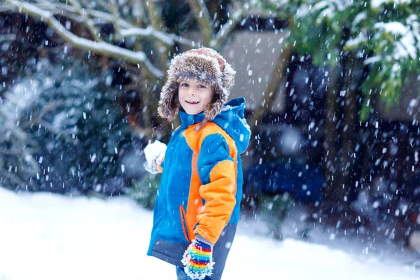 Happy kid boy having fun with snow in winter — Stock Photo, Image