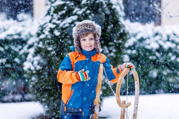 Menino pequeno que tem fung com passeio de trenó no inverno — Fotografia de Stock