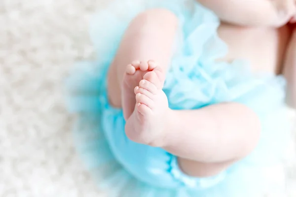 Gros plan des jambes et des pieds de la petite fille sur fond blanc portant une jupe tutu turquoise . — Photo