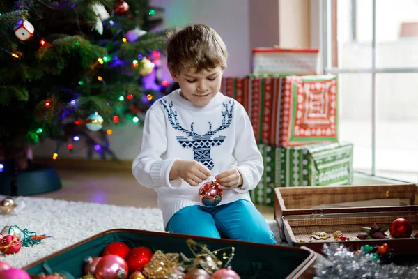 Güzel çocuk ve renkli eski yılbaşı oyuncakları ve topları. Çocuk Noel ağacı süslemesi — Stok fotoğraf