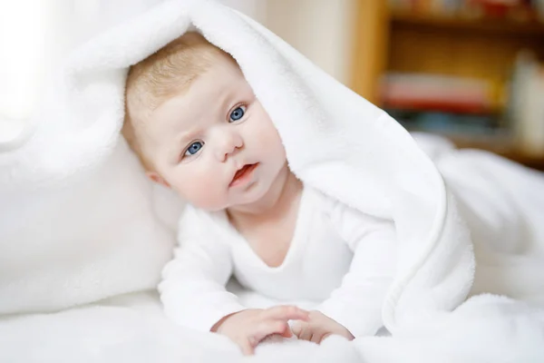 Baby girl wearing white towel or winter overal in white sunny bedroom — Stock Photo, Image