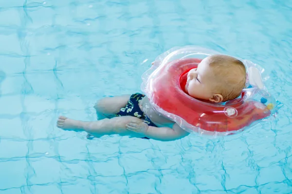 Niedliches kleines Kind lernt Schwimmen mit Schwimmring im Hallenbad — Stockfoto