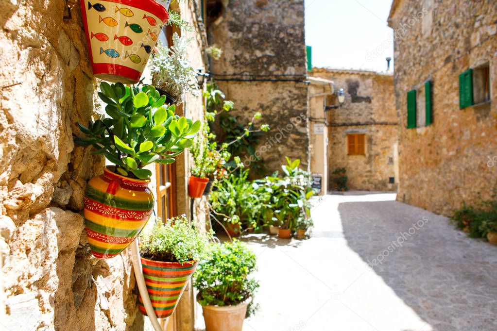 Beautiful street in Valldemossa with traditional flower decoration, famous old mediterranean village of Majorca. Balearic island Mallorca, Spain