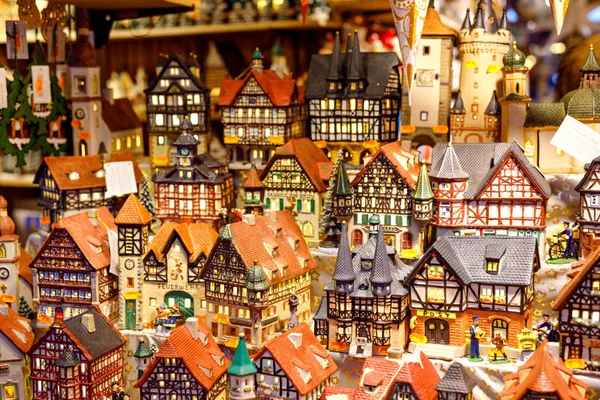 Different decoration, toy for xmas tree on christmas market, close up of cozy handmade houses, churches and castles. German traditional craft — Stock Photo, Image