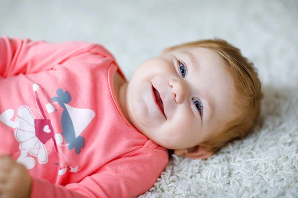 Little cute baby girl learning to crawl. Healthy child crawling in kids room with colorful toys. Back view of baby legs. Cute toddler discovering home and learning different skills — Stock Photo, Image