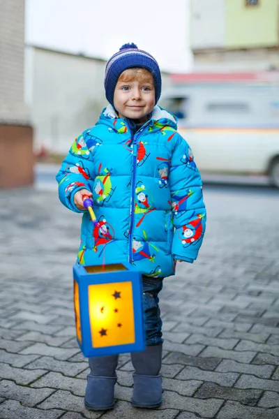 Little kid boy holding selfmade lanterns for a Halloween or St. Martin procession. Beautiful healthy cute child happy about children and family parade in kindergarten. German tradition Martinsumzug — Stock Photo, Image