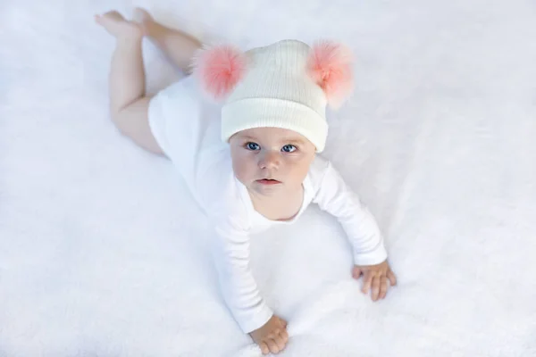Cute adorable baby child with warm white and pink hat with cute bobbles — Stock Photo, Image