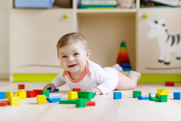 Bonito bebê menina brincando com brinquedos chocalho colorido — Fotografia de Stock