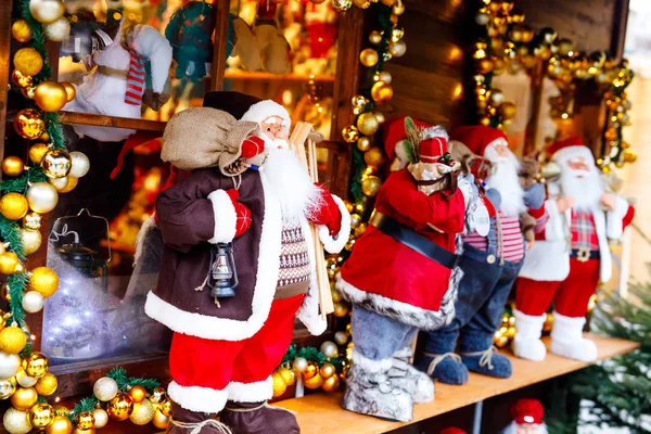 christmas market in Germany cute Santa Clause called Weihnachtsmann in German decoration, gifts, Xmas tree balls and illumination for sale