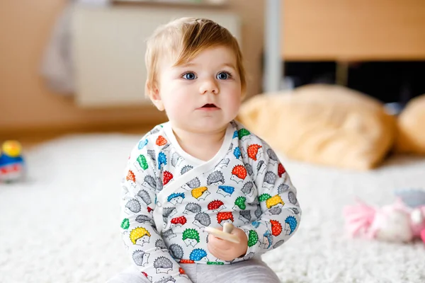 Gorgeous cute beautiful little baby girl playing with educational toys like wooden puzzle at home or nursery. Happy healthy child having fun with colorful different toys. Kid learning different skills — Stock Photo, Image