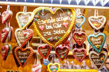 Gingerbread Hearts at German Christmas Market. Nuremberg, Munich, Fulda, Berlin, Hamburg xmas market in Germany. In German language It is beautiful to be with you. clipart