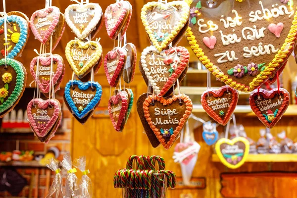 Gingerbread Hearts at German Christmas Market. Nuremberg, Munich, Fulda, Berlin, Hamburg xmas market in Germany. In German language It is beautiful to be with you.