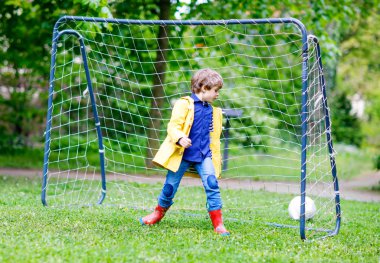 Futbol ve futbol oynamak ve eğlenmek etkin şirin küçük çocuk çocuk