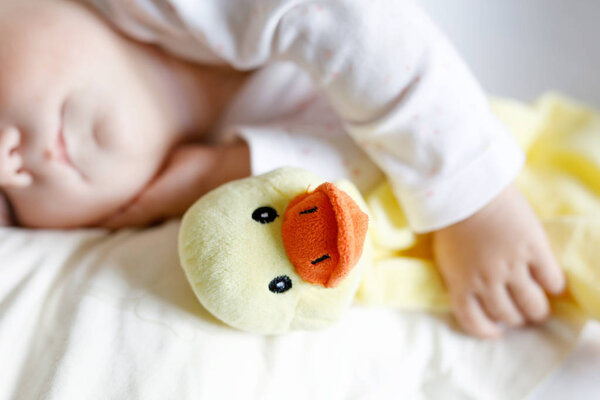 Cute adorable baby girl of 6 months sleeping peaceful in bed