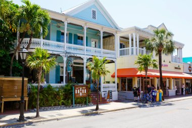 KEY WEST, FLORIDA USA - APRIL 13, 2016: The historic and popular center and Duval Street in downtown Key West. Beautiful small town in Florida, United States of America clipart