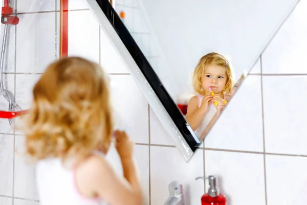 Nettes entzückendes Kleinkind Mädchen mit Zahnbürste und Zähneputzen im Badezimmer nach dem Schlafen. Wunderschönes Baby, das lernt Milchzähne zu putzen. Morgens gesunde Hygiene-Routine für Kinder — Stockfoto