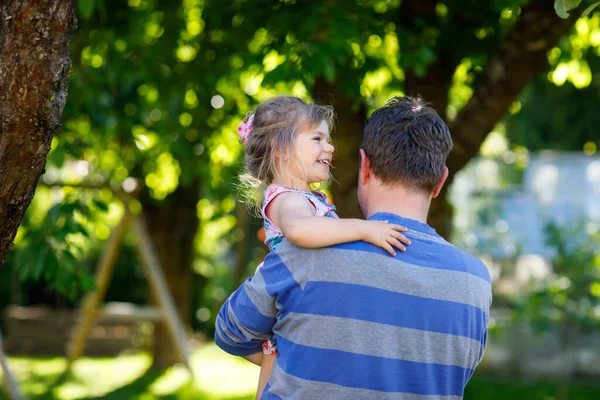 Glad ung far har roligt söt småbarn dotter, familj porträtt tillsammans. man med vacker liten flicka i sommarträdgården. Pappa med barn utomhus, kramas. Kärlek, band. — Stockfoto