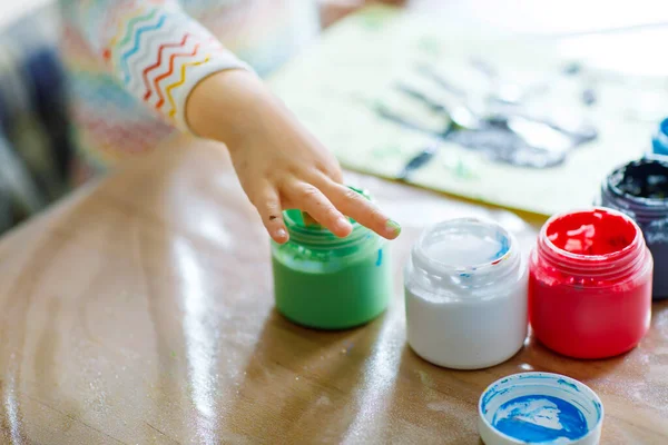 Closeup of little creative toddler girl painting with finger colors an owl bird. Child having fun with drawing at home, in kindergaten or preschool. Games, education and distance learning for kids. — Stock Photo, Image