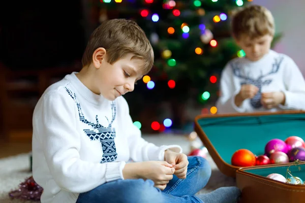 Piękny chłopiec z kolorowych zabawek vintage xmas i piłki w starej walizce. dzieci dekorowanie choinki — Zdjęcie stockowe