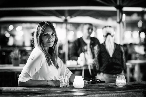 Mladá žena pije mojito koktejl v kavárně na terase v horkém letním dni. Krásná obchodnice si užívá teplý večer v restauraci po práci. Šťastný úsměv, paní.. — Stock fotografie
